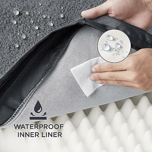 Hands demonstrating waterproof inner liner of mattress cover.