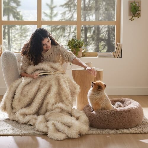 Woman reading and petting a dog indoors